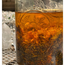 Load image into Gallery viewer, herbs and oils infusing in a jar in the poppy and someday apothecary in traverse city michigan