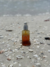 Load image into Gallery viewer, bottle of sea sun shield outside on the michigan beach for use
