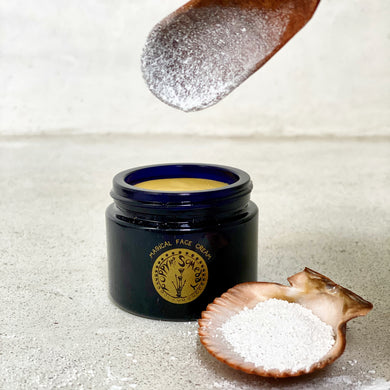 open jar display of magical face cream with pearl powder in a shell handcrafted by poppy and someday in michigan using locally grown botanicals